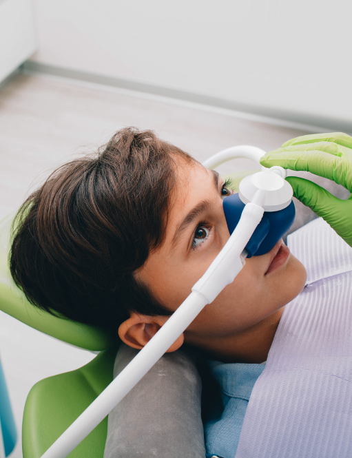 Get sedation options for restorative dental procedures in Somerset, NJ Kid with sedation mask on in dentist chair | Best family dentist for children and adults in Somerset, NJ