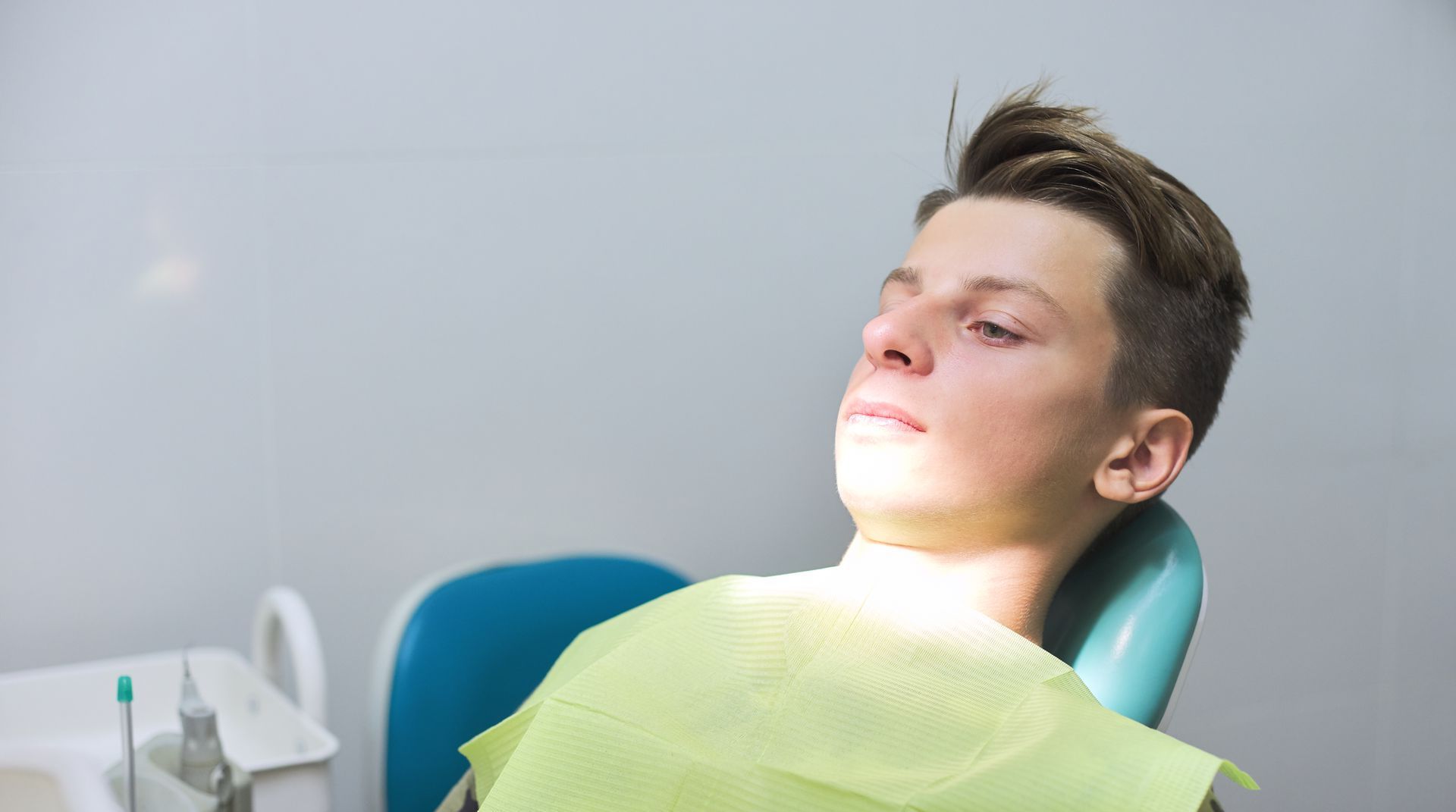 Relax with sedation options during your restorative dental appointment in Somerset, NJ teenager anxious in dental chair | Sedation options for crowns, gum disease therapy, and implants | Somerset, NJ