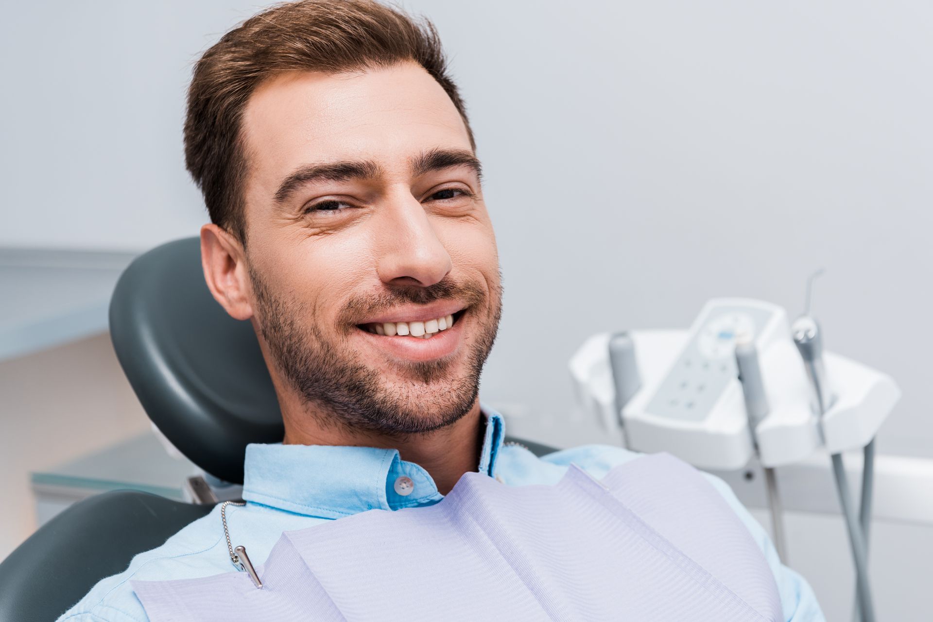 Get dentures, implants, and gum disease therapy in Somerset, NJ. Man smiling after getting dentures at our family dentist in Somerset, NJ