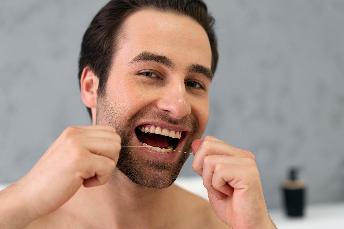 REGULAR FLOSSING | Man flossing | Prevent gum disease in Somerset NJ