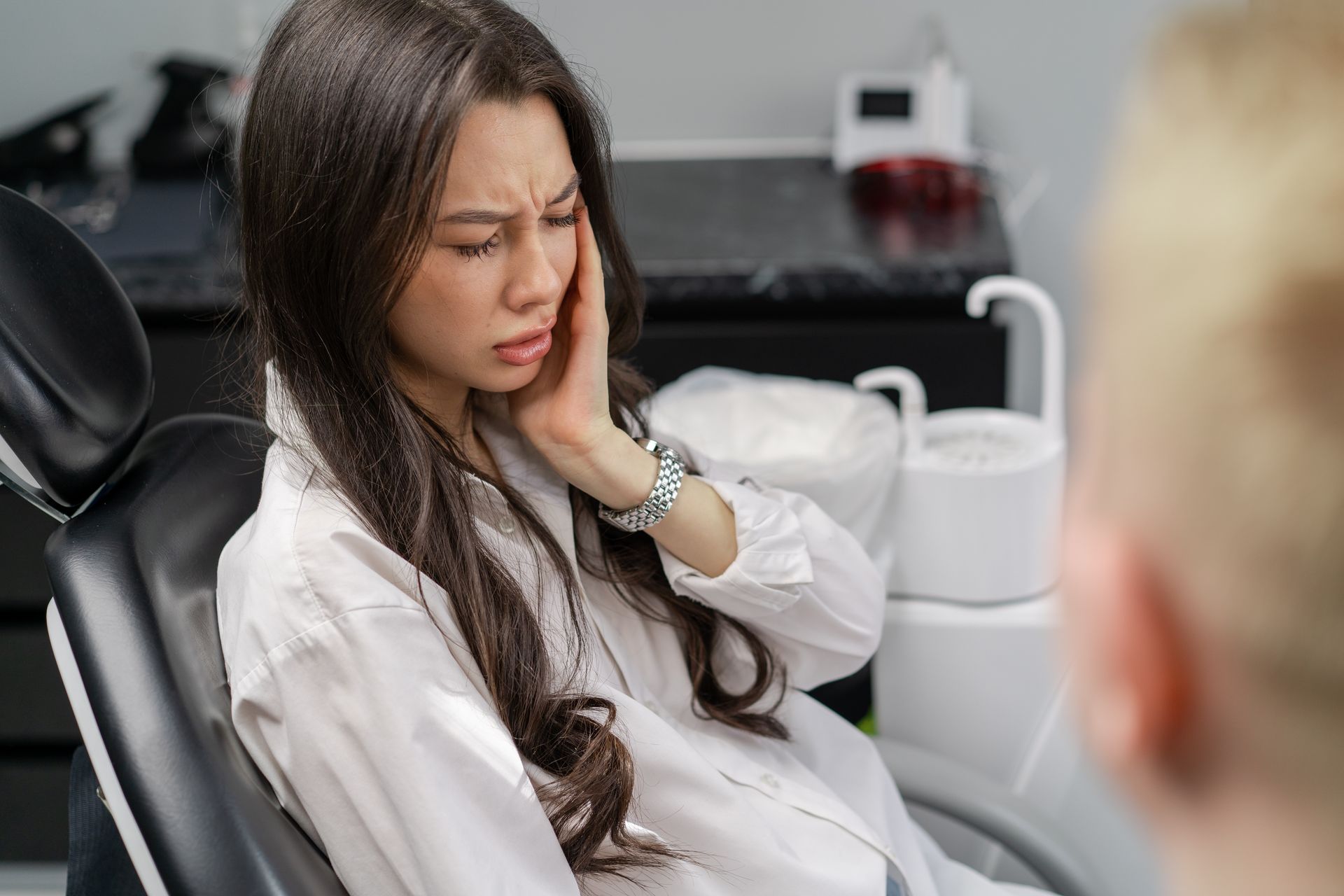 Call us for same day emergency dental care near Somerset, NJ woman in pain holding mouth | Same day emergency dentist in Somerset NJ