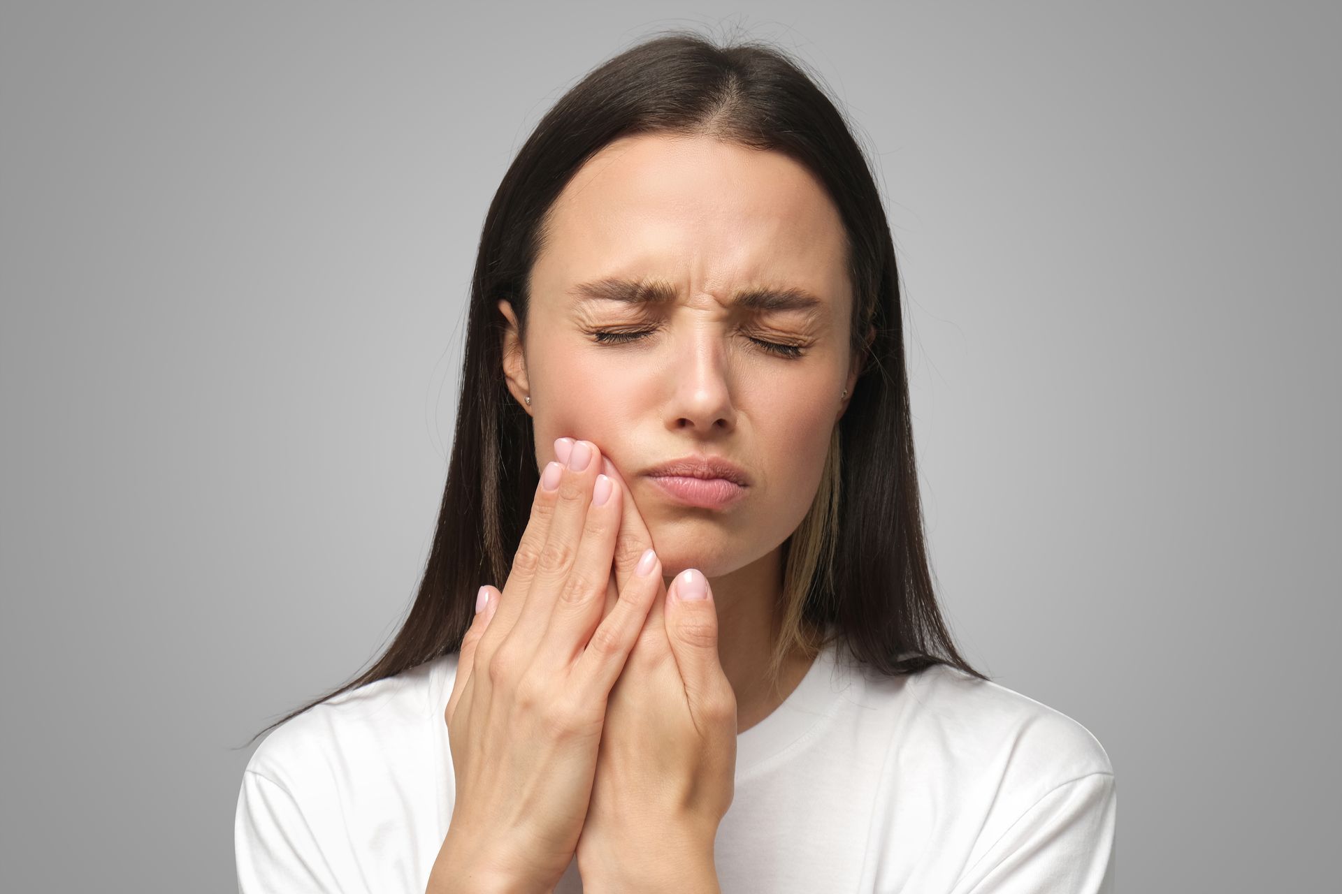 Get same day dental care from our emergency dentist in Somerset, NJ woman holding mouth in pain | same day emergency family dentist in Somerset NJ