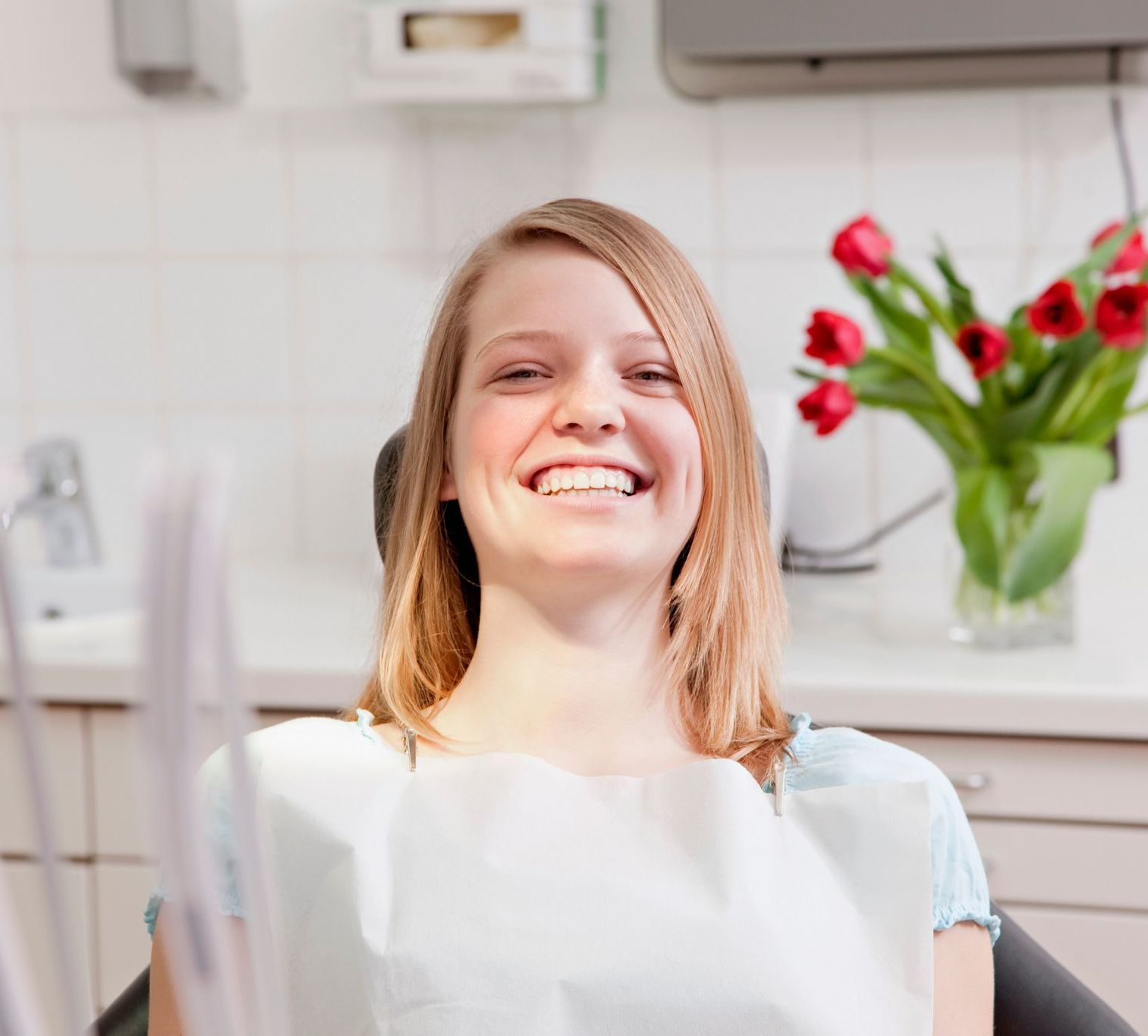 Feel confident in teeth cleanings at our natural, biological dentist in Somerset, NJ. woman smiling in dentist chair because of biological dentistry in Somerset, NJ.