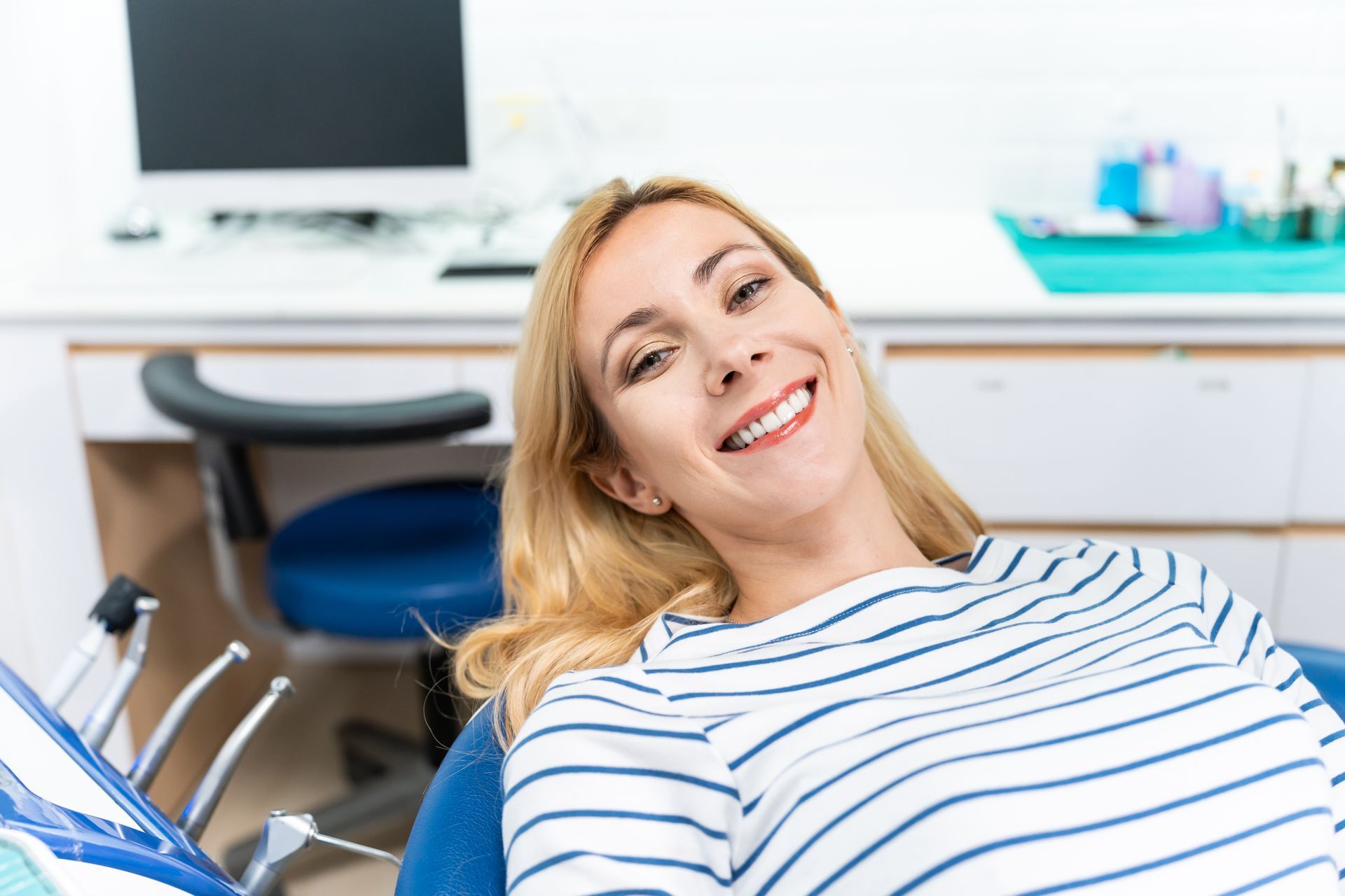 Teeth cleanings, dentures, sleep apnea therapy Woman smiling after comprehensive dental exam with teeth cleaning | Somerset NJ