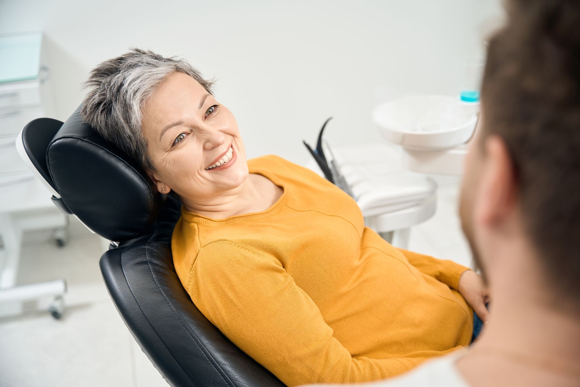 Get restorative dental care near Somerset, NJ woman smiling during dental procedure for crowns and fillings | Cigna, Aetna, MetLife | Somerset, NJ