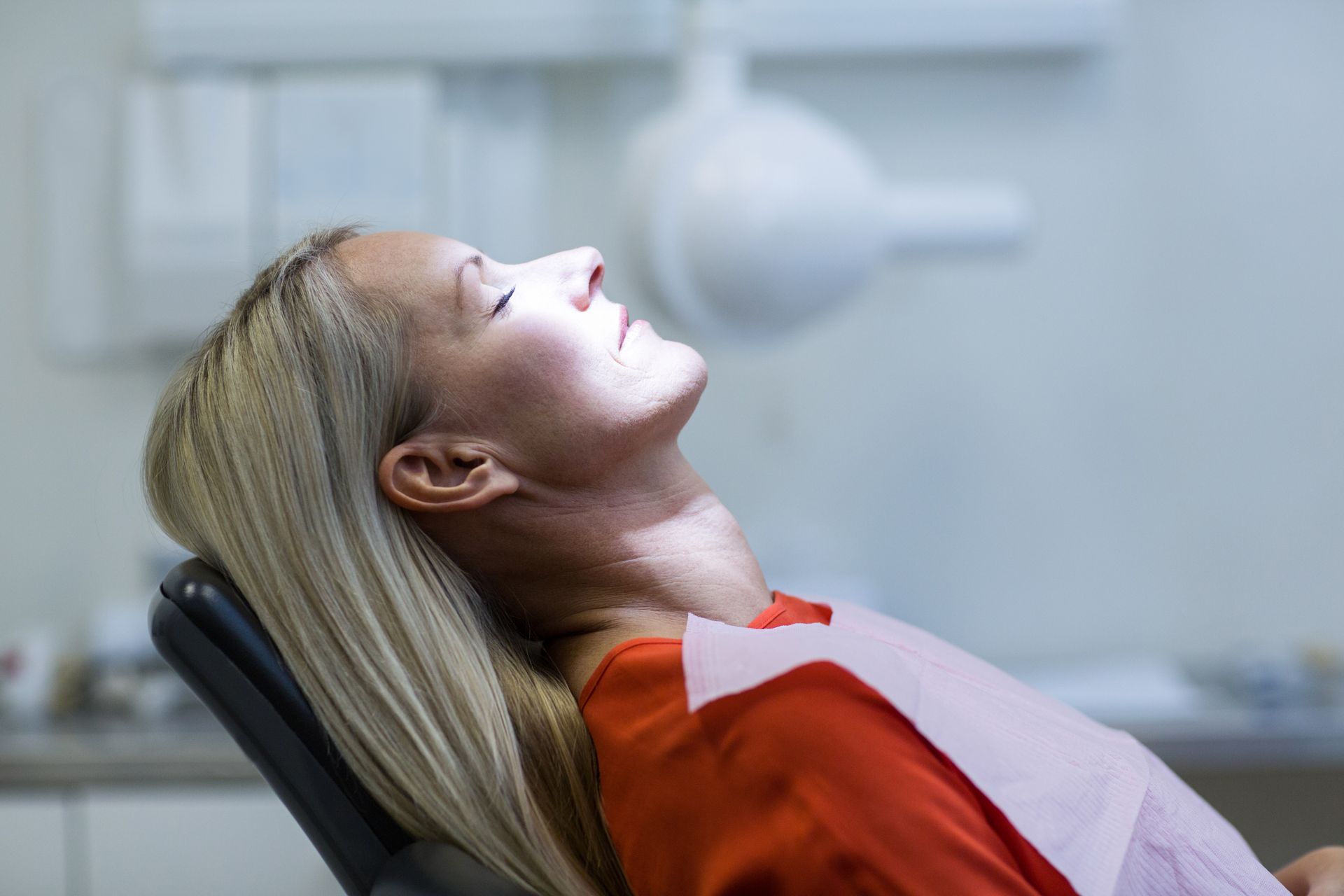 Calm dental anxiety with sedation options in Somerset, NJ woman asleep in dental chair | Affordable sedation dentist in Somerset, NJ