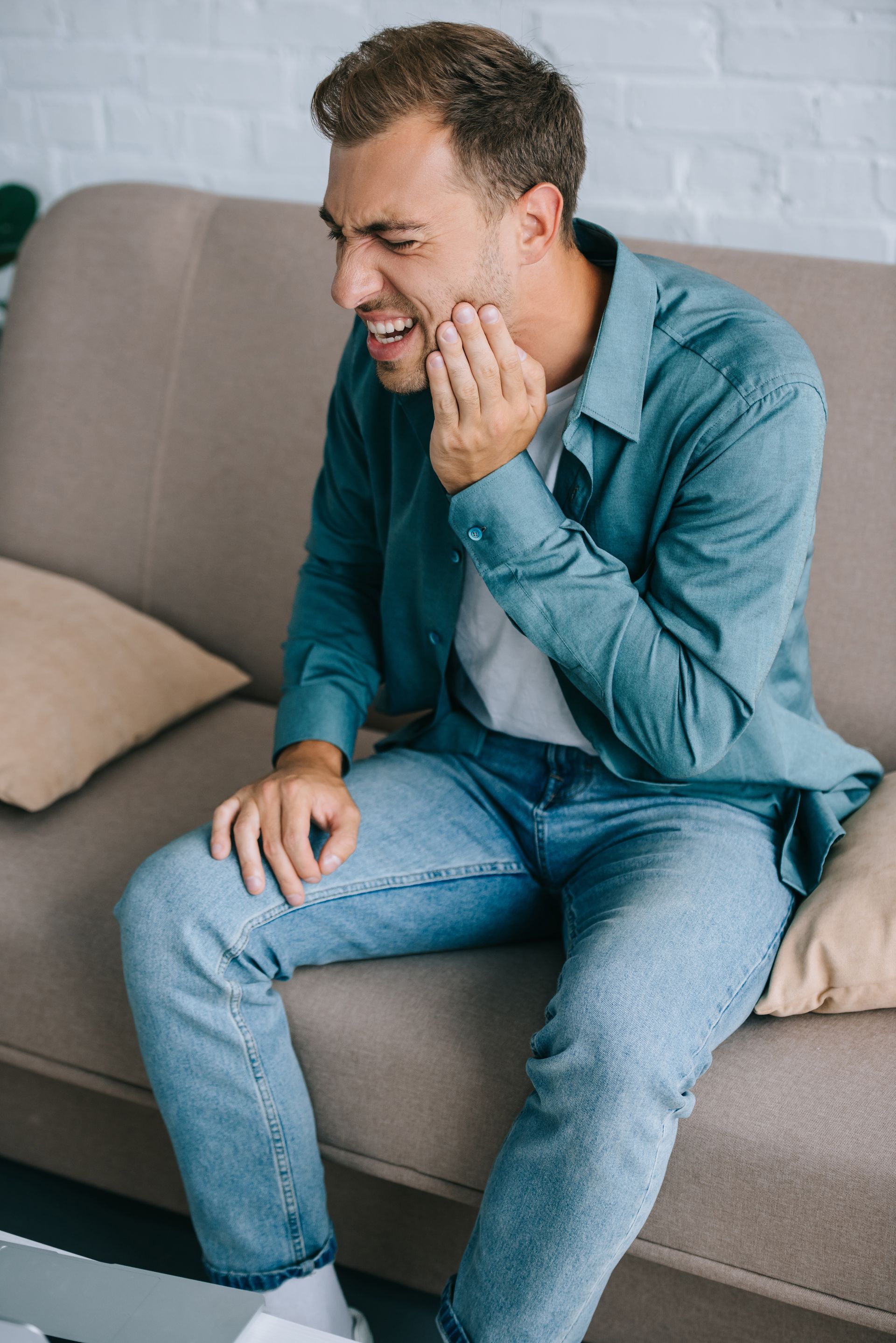 Get same day emergency dental care near Somerset, NJ. Man holding mouth | Same day dentist in Somerset NJ for emergencies | Fix broken teeth, crowns, and more.