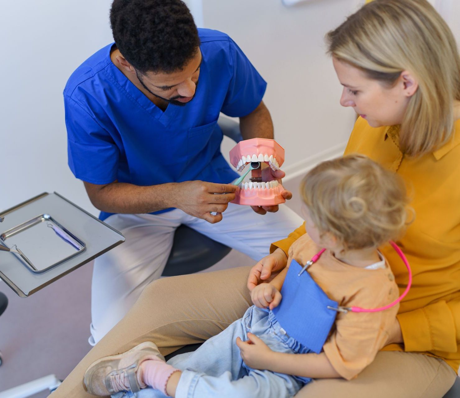 We understand the different between dental care for children and adults. Dentist teaching teeth cleaning and brushing to mom and child | Family dentist with holistic approach | Somerset NJ