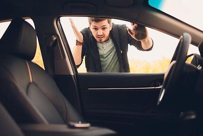 A man is looking out of the window of a car.