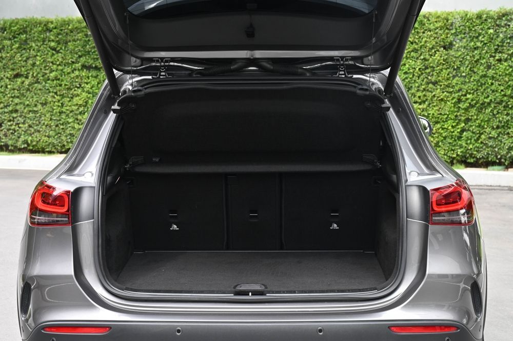 The trunk of a mercedes benz gla is open and empty.
