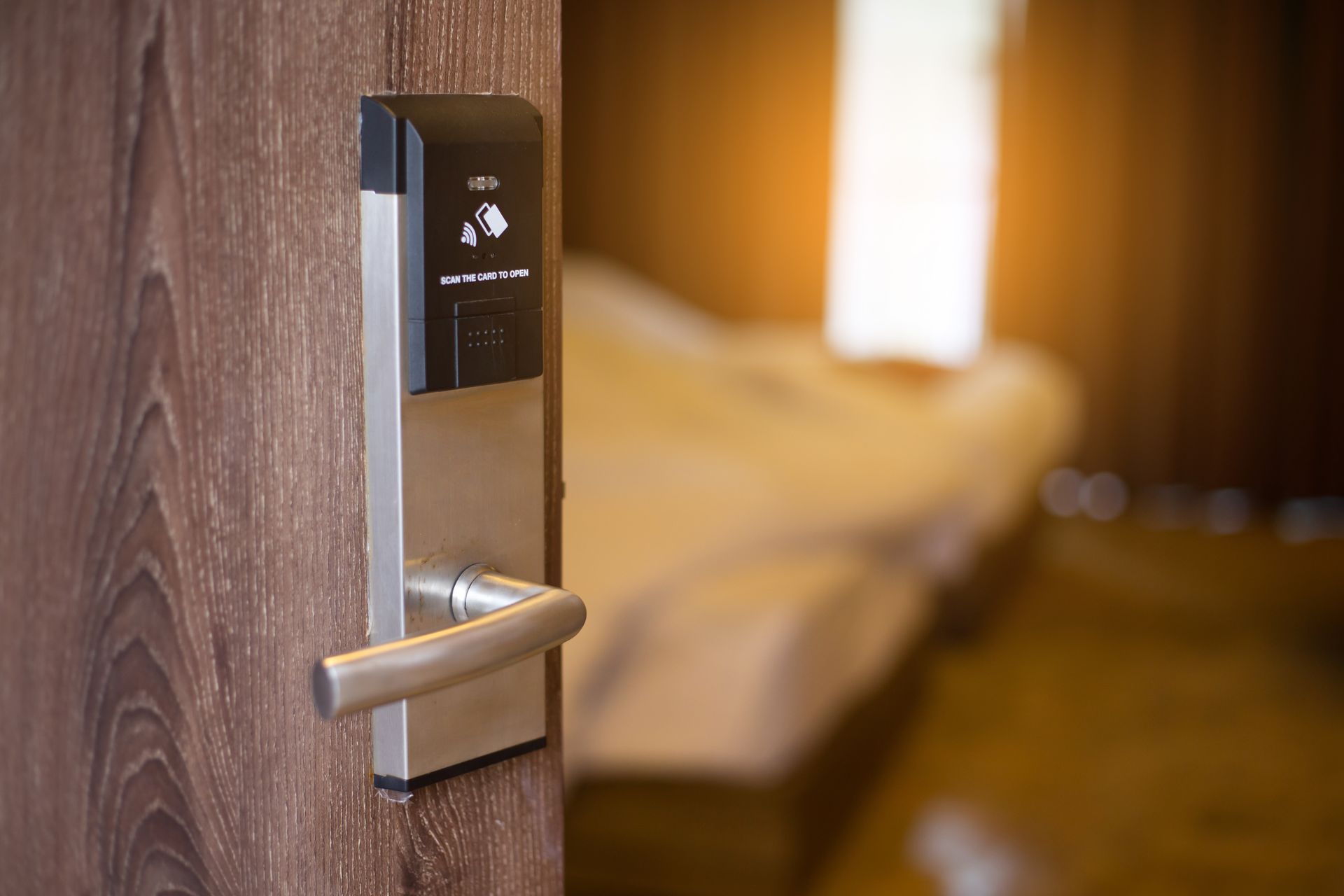 A hotel room with a door lock and a bed.