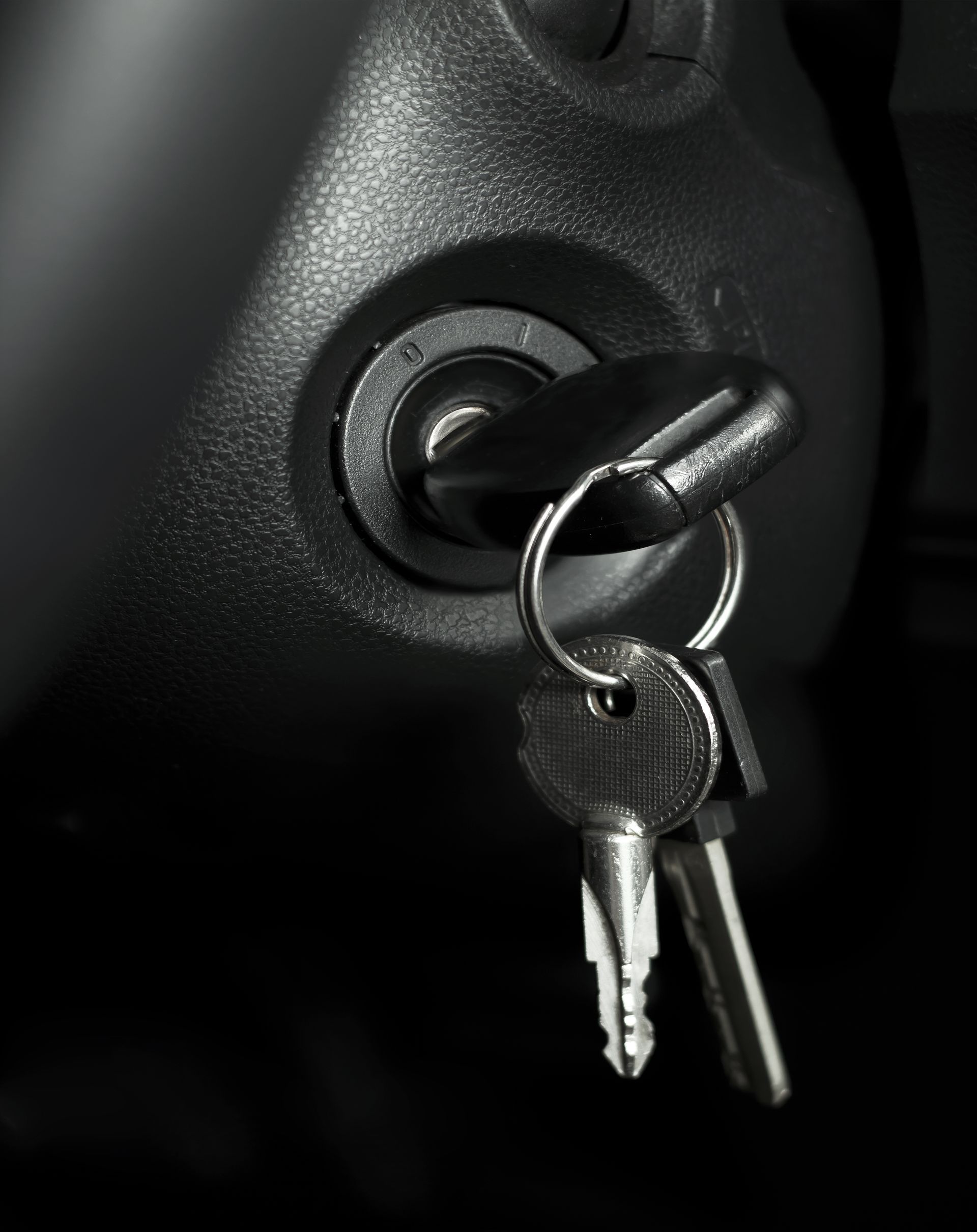 A pair of keys hanging from a car ignition