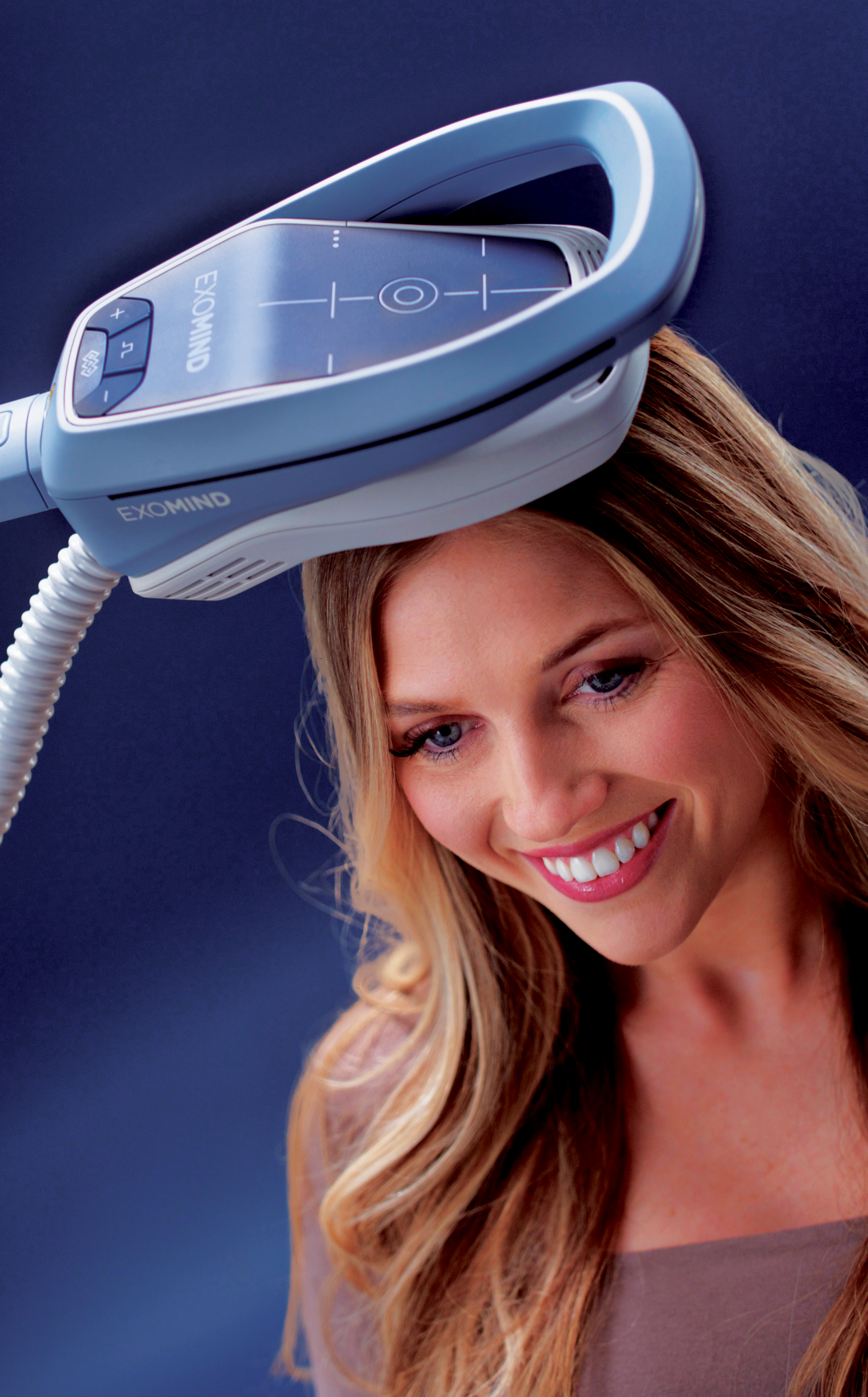 A smiling person has a blue medical device for transcranial magnetic stimulation positioned over their head.