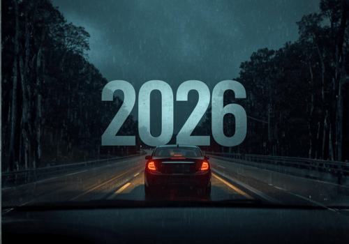 Car driving on a dark wet road at night with large “2026” text over the scene