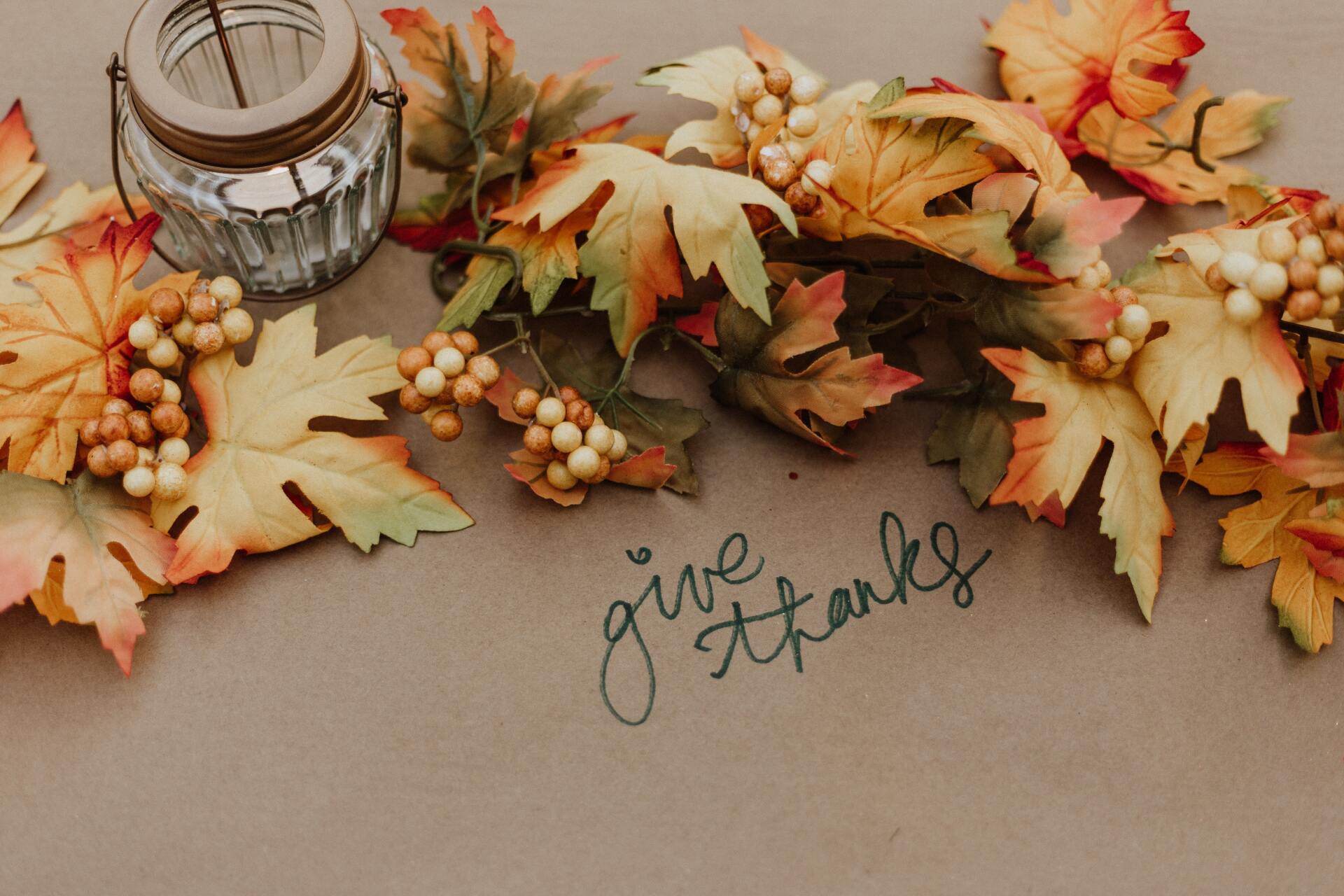 A brown piece of paper with the words give thanks written on it