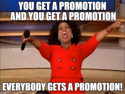 Oprah winfrey is holding a microphone with her arms in the air.