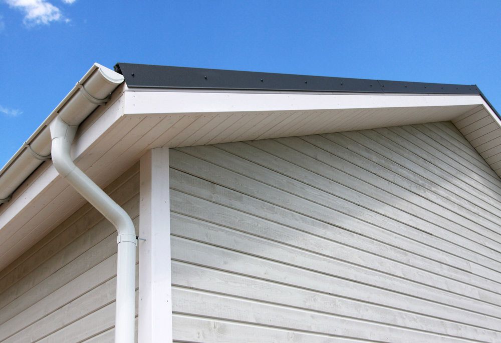 A White House With a Gutter on the Side of It — DnA Steel Direct in Ciccone, NT