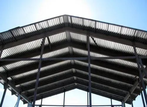 The Sun is Shining Through the Roof of a Building Under Construction — DnA Steel Direct in Ciccone, NT