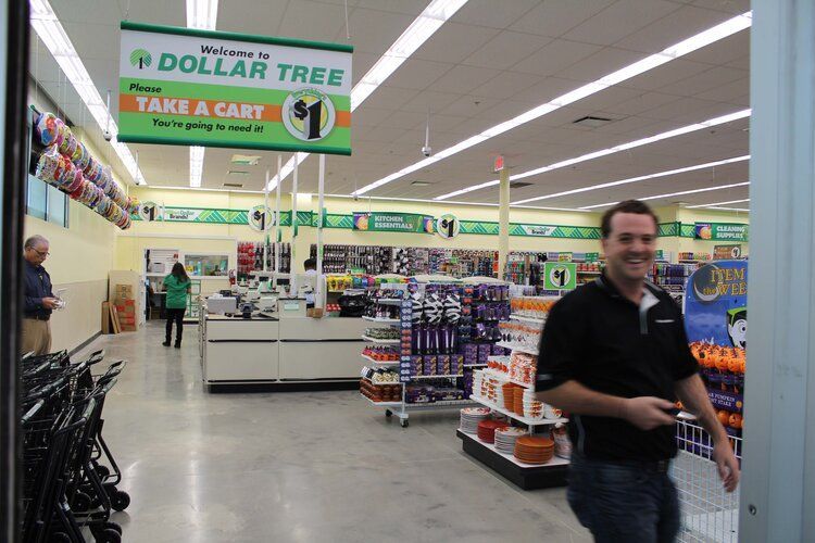 A man is walking through a dollar tree store