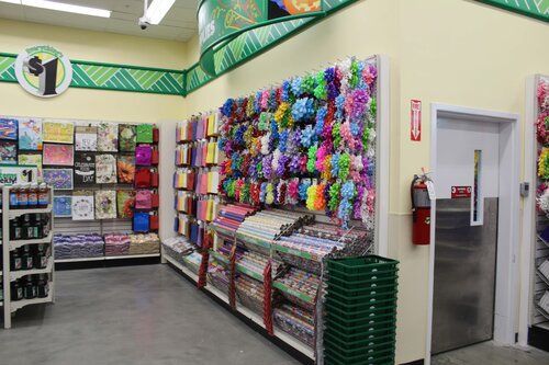 The inside of a dollar tree store with a fire extinguisher on the wall.