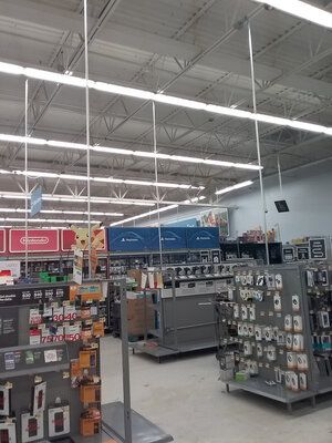 The inside of a store with a lot of lights hanging from the ceiling.