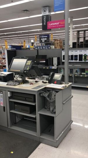 A cash register in a store with a computer on it