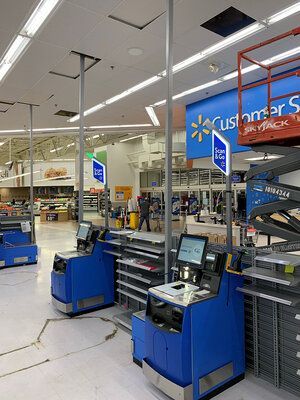 The inside of a walmart store with a sign that says customer service.