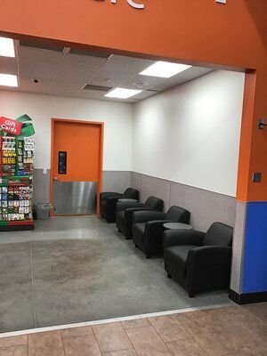 A waiting room with chairs and tables in a store.