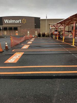 A parking lot in front of a walmart store.