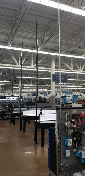 A large empty store with lots of shelves and tables.