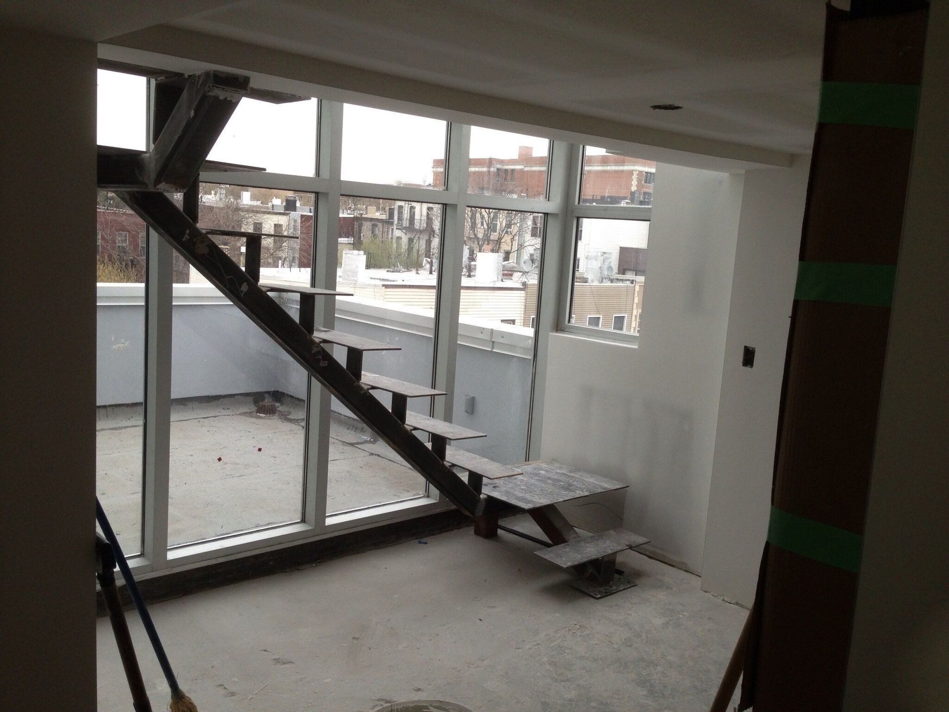 A room with a staircase and lots of windows