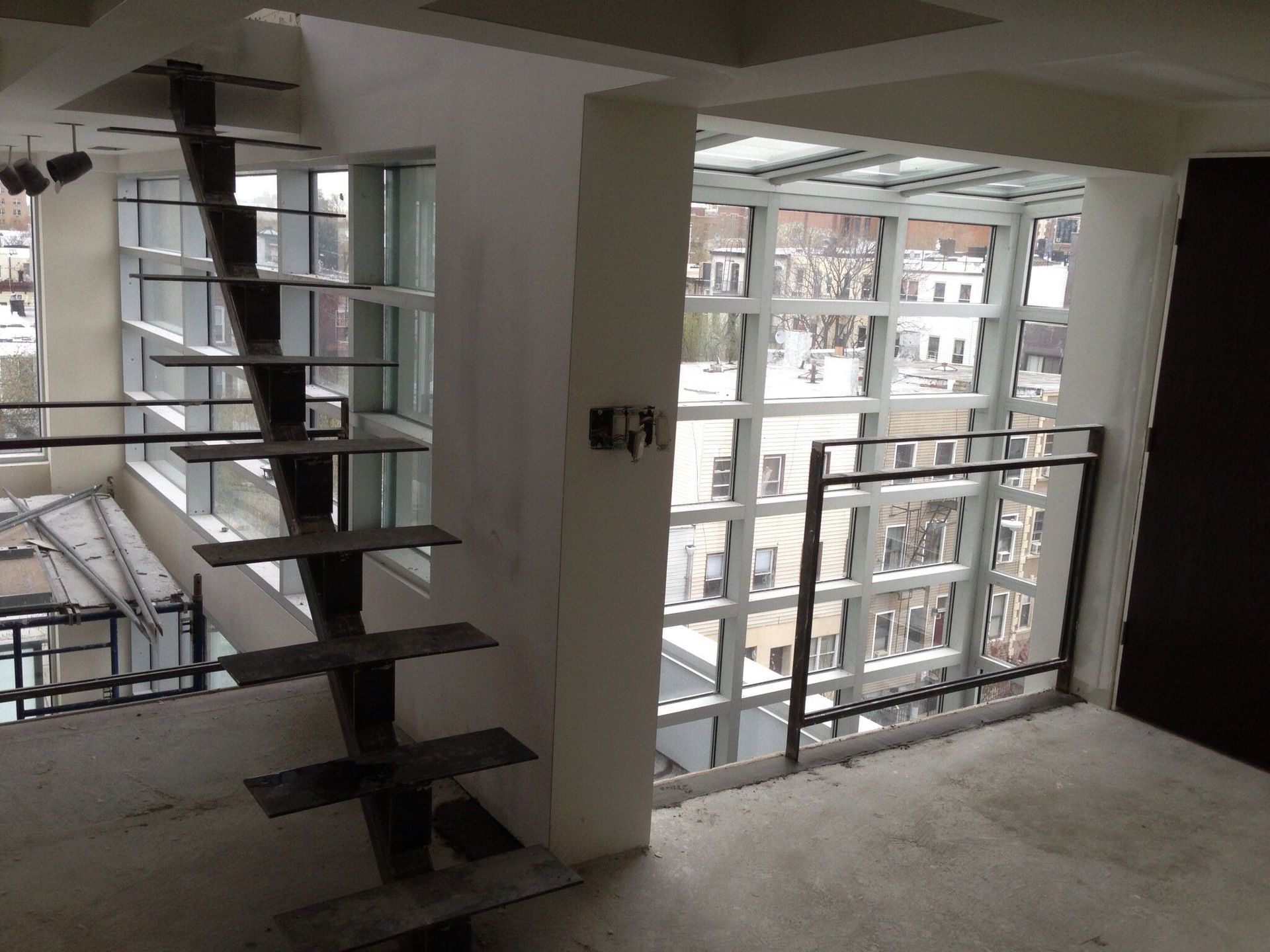 An empty room with a staircase leading up to the second floor