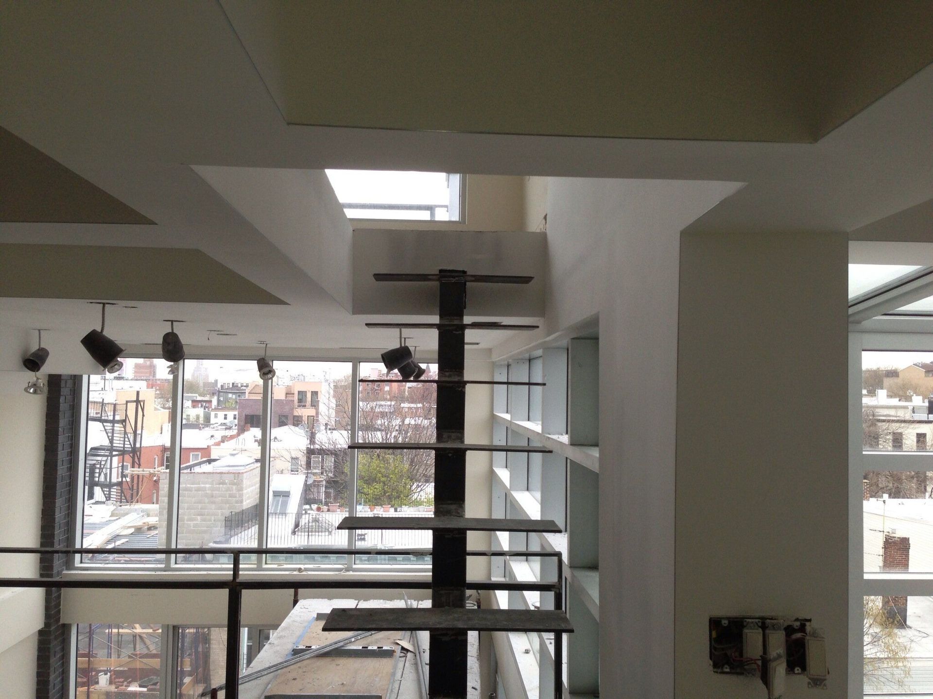 A room with a lot of windows and a ceiling fan