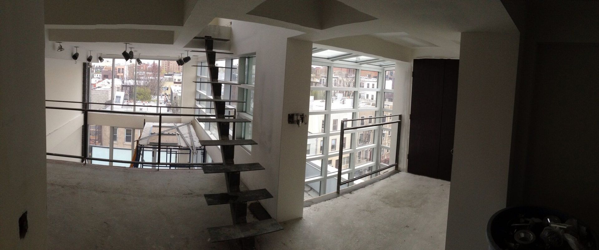 A person is standing in a room with a lot of windows.