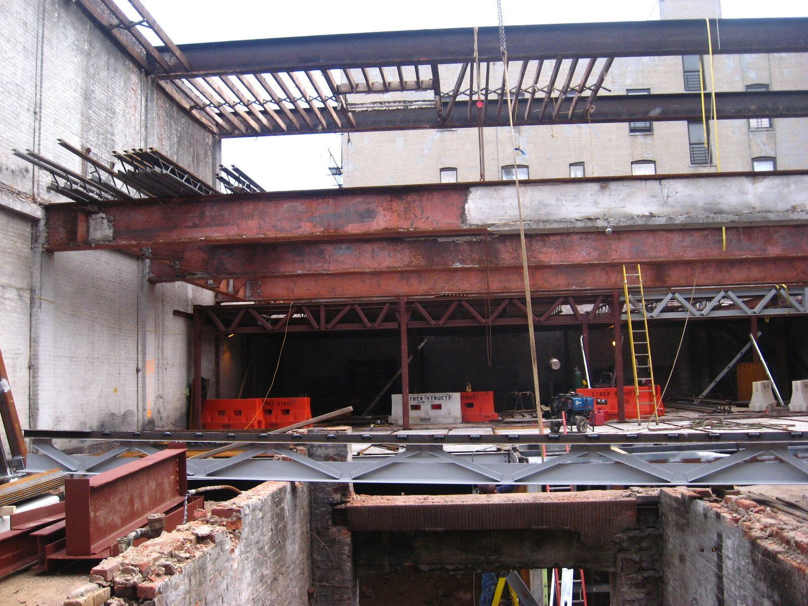 A building under construction with a ladder in the foreground