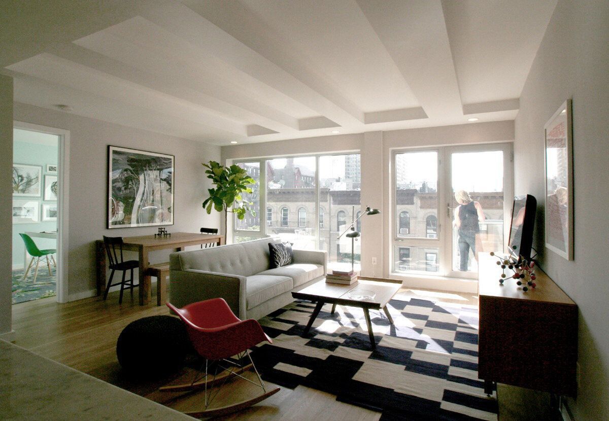 A living room with a couch and a rocking chair
