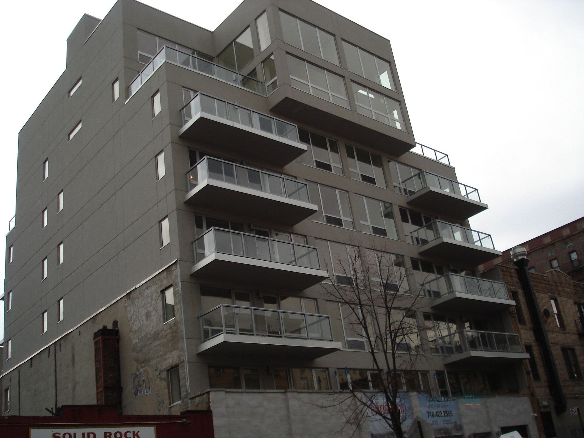 A building with balconies and a sign that says sound rock