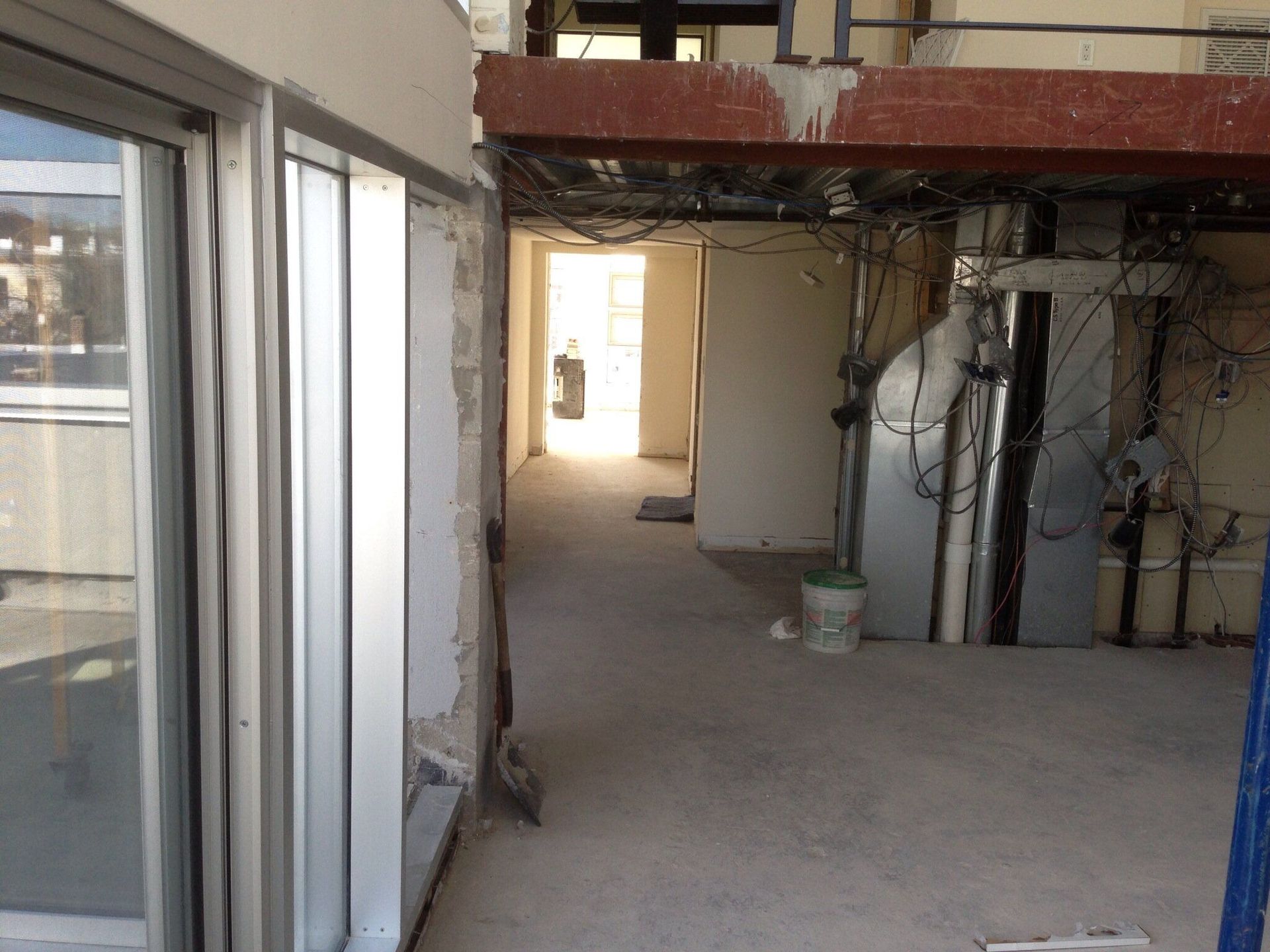 An empty hallway with a bucket on the floor