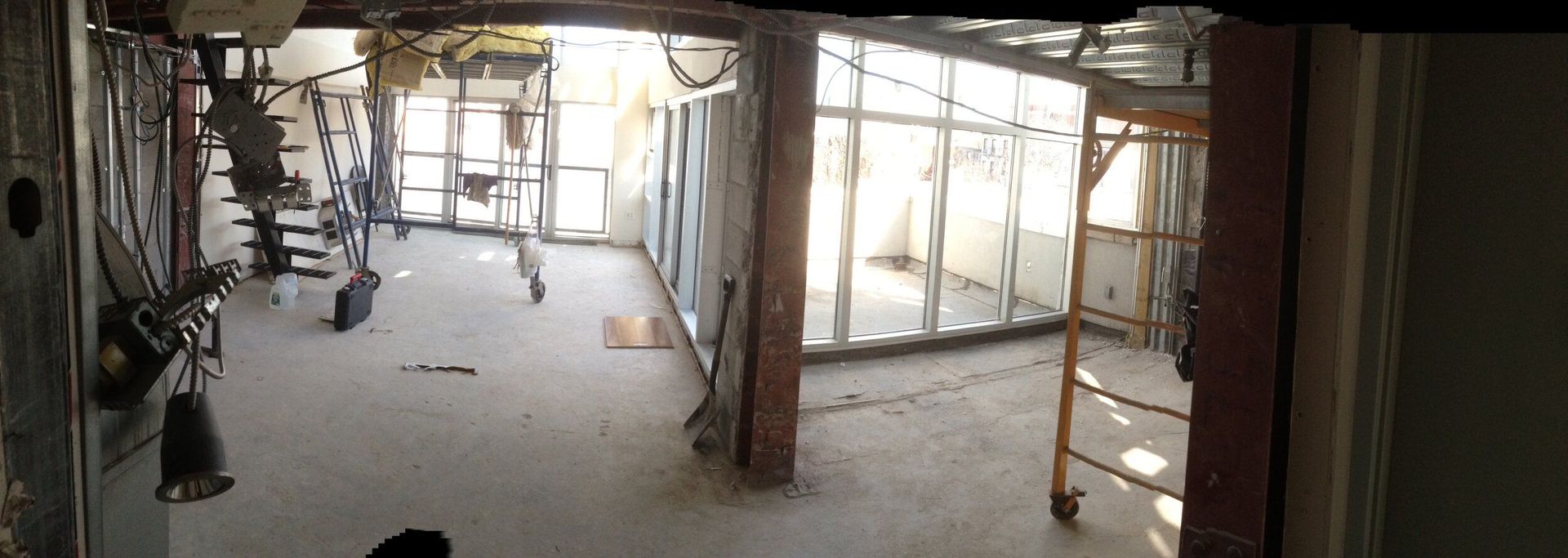 A large room with a lot of windows and scaffolding