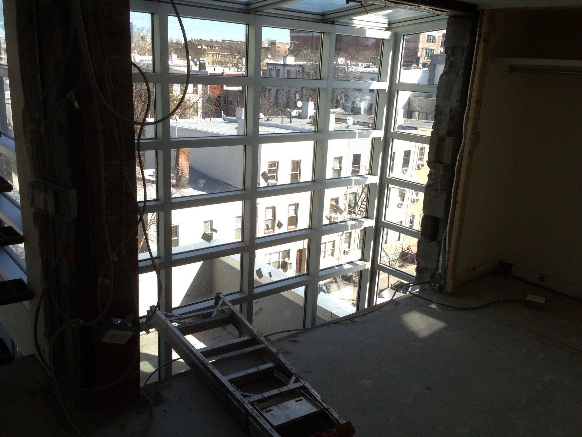 A ladder is sitting in front of a large window