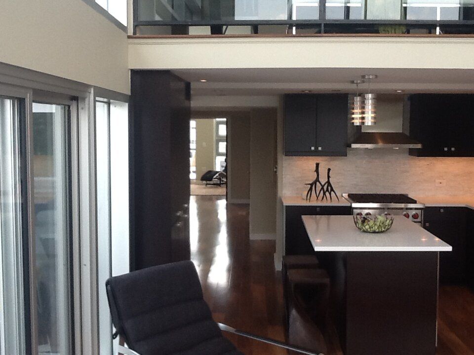 A kitchen with black cabinets and a white counter top
