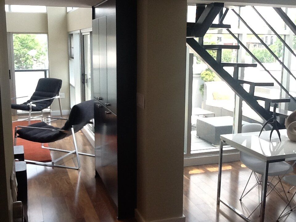 A living room with a staircase leading up to the second floor