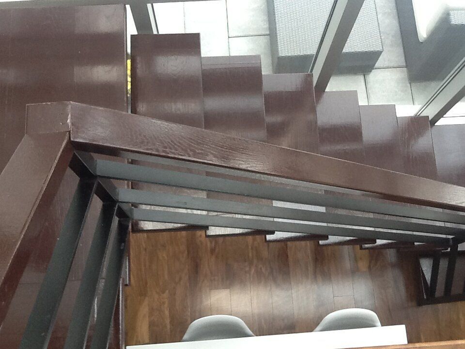 An aerial view of a wooden staircase with a metal railing