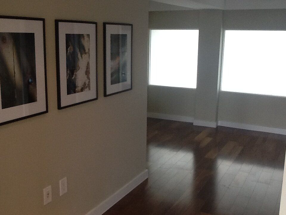 A hallway with three framed pictures on the wall