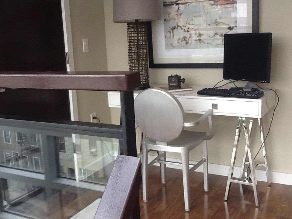 A desk with a computer and a lamp on it