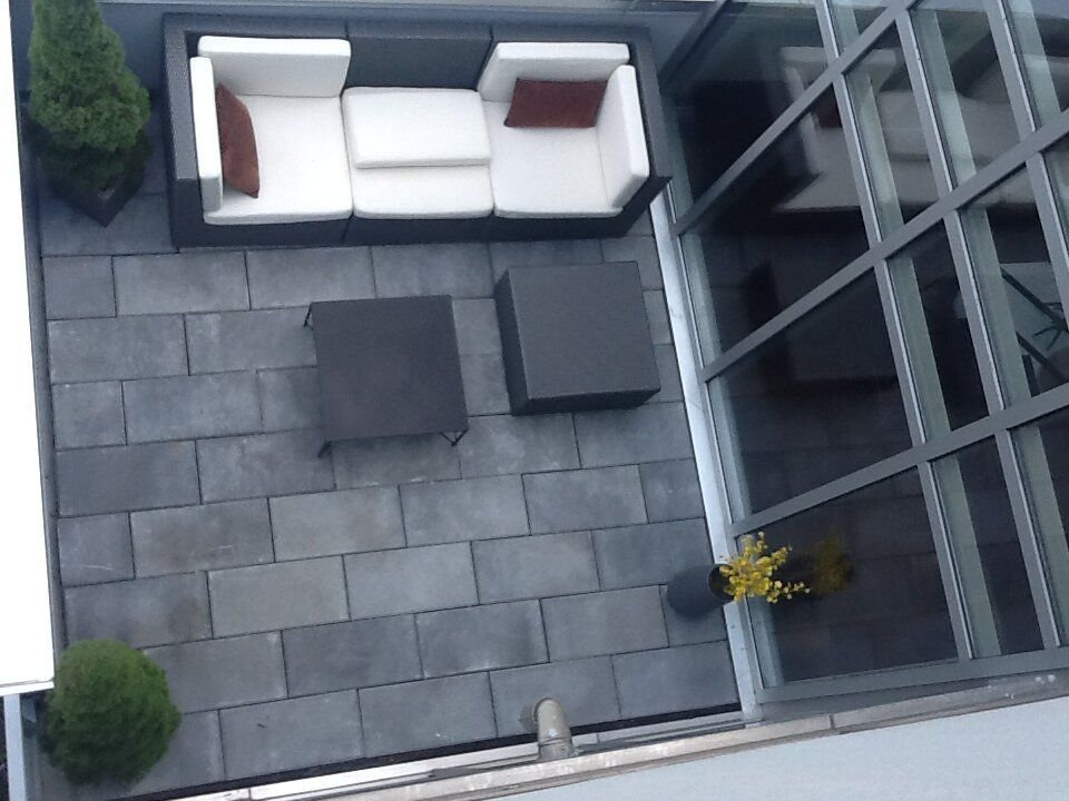 An aerial view of a patio with a couch and tables