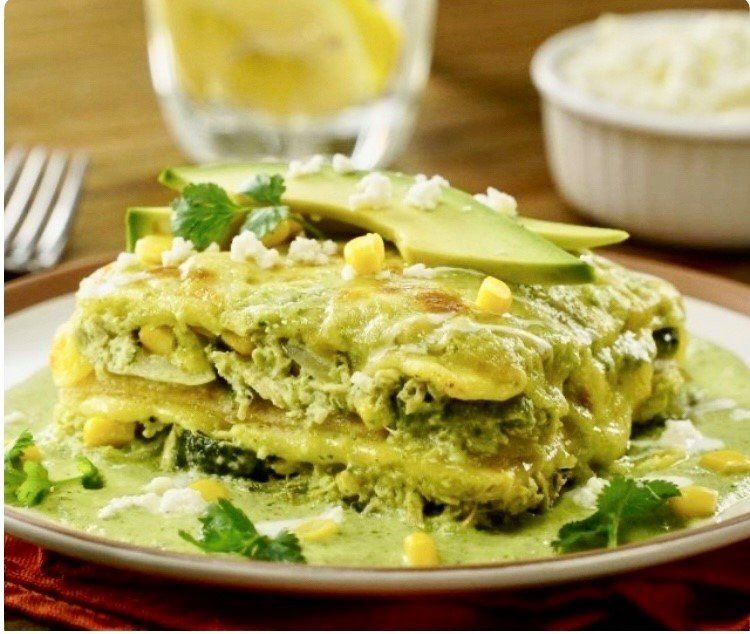 A close up of a plate of food with avocado on top