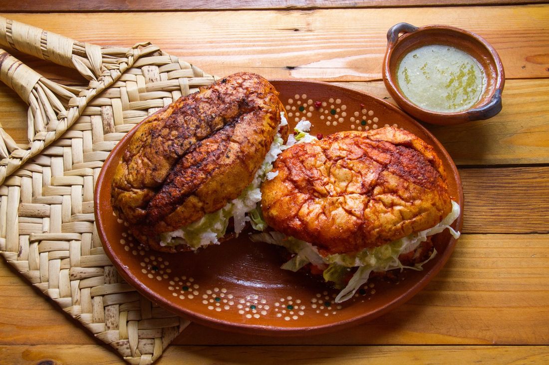 A close up of a plate of food on a wooden table.