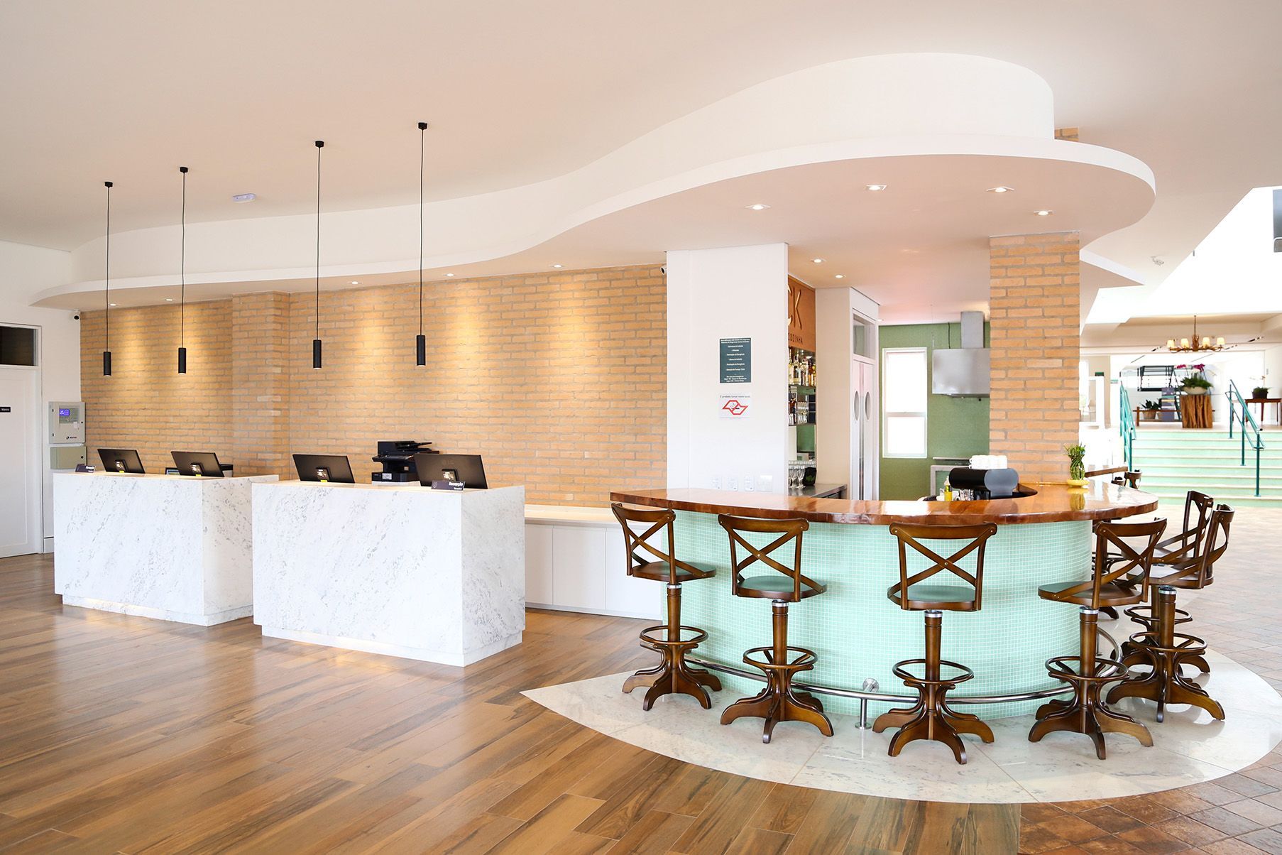 Um lobby de hotel com um bar e bancos