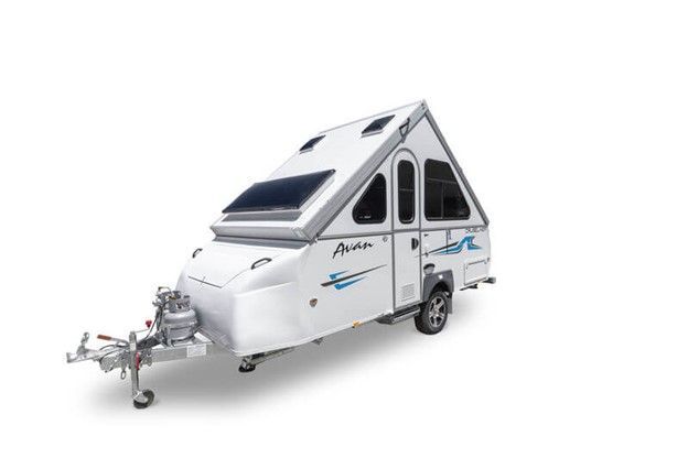 a white caravan with a green stripe on the side is on a white background .